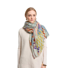 Load image into Gallery viewer, Woman wearing a colorful patterned scarf on a white background