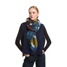 Load image into Gallery viewer, Woman wearing a colorful scarf and navy vest on a white background