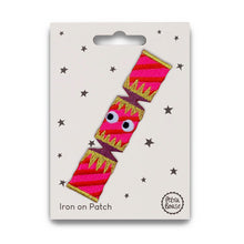 Load image into Gallery viewer, Pink and gold monster-shaped iron on patch on a white card with star patterns, branded 'Petra Boase'.