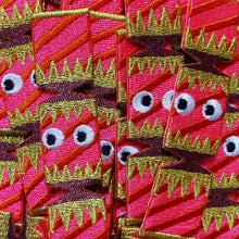 Load image into Gallery viewer, Close-up of pink fabric with gold and black patterns