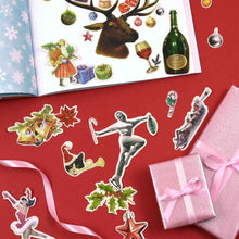 Load image into Gallery viewer, Collection of Christmas-themed stickers on a red background with a pink gift box.