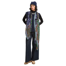 Load image into Gallery viewer, Person wearing a long, patterned scarf with a white background