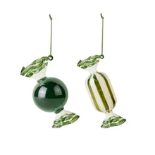 Load image into Gallery viewer, Two glass candy ornaments, one green sphere and one striped candy, on a white background.
