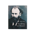 A book cover featuring a black and white photograph of Edouard Manet, with the title 'Looking at Manet' and the author's name, Émile Zola, displayed.