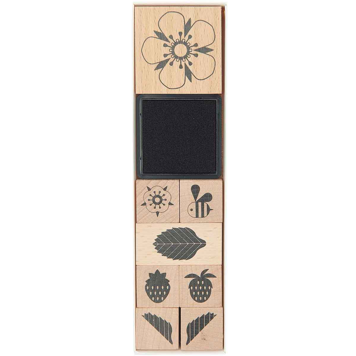 Set of wooden stamps with various flower designs on a white background
