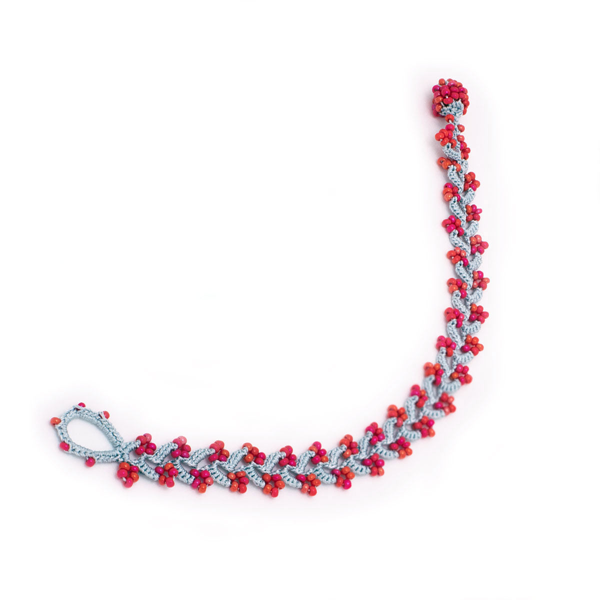 Bracelet with red and silver beads on a white background