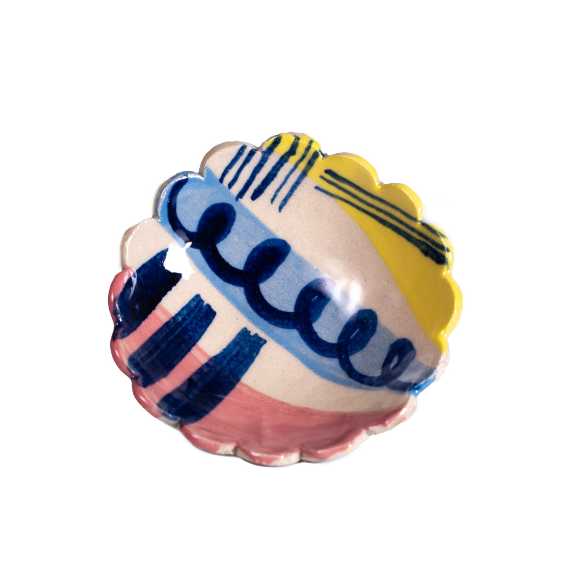 Decorative shell-shaped object with blue and yellow patterns on a white background