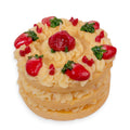 Candle shaped like a Two-layered cake with strawberry and leaf decorations on a white background