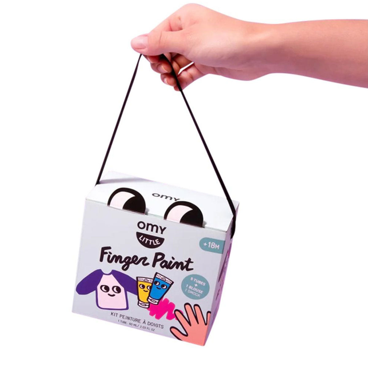 Hand holding a box of Omy Little Finger Paints against a white background