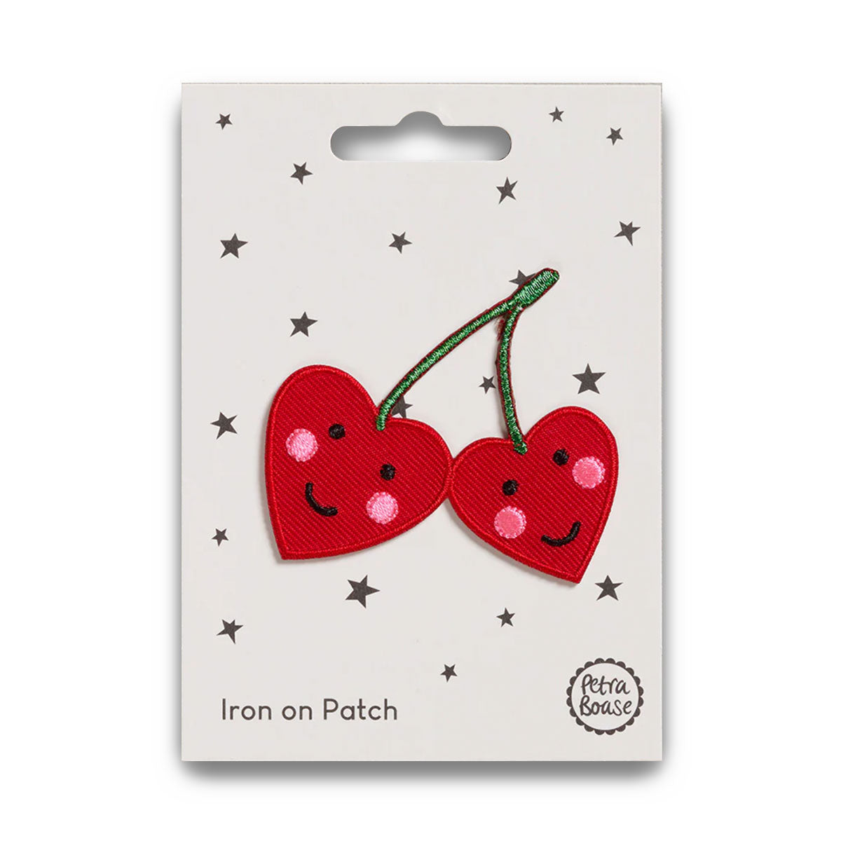 Iron on patch of two smiling red cherries with a white backing and star decorations.