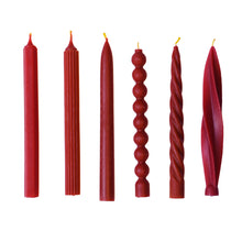 Load image into Gallery viewer, A collection of red beeswax dinner candles in assorted shapes, displayed side by side.
